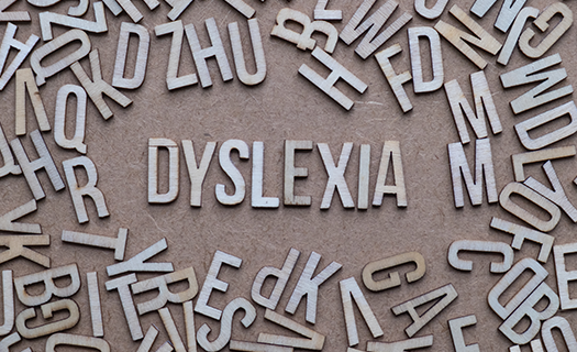Dyslexia spelled out in center surrounded by varrious letters