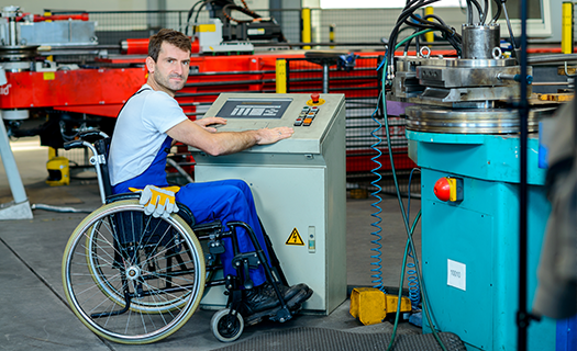 disabled-worker-wheelchair-factory-on-machine.png