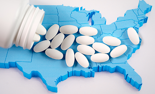White prescription pharmaceutical pills on map of United States