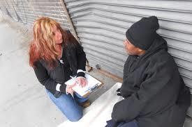 social worker interviewing homeless man outside