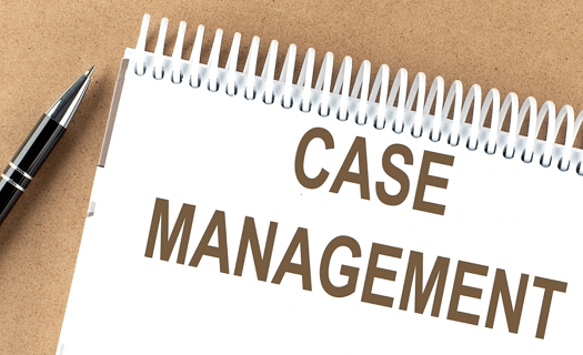 Case Management written on a spiral notepad with a pen on the desk beside.