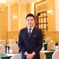 young chinese waiter service in dining room