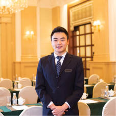 young chinese waiter service in dining room